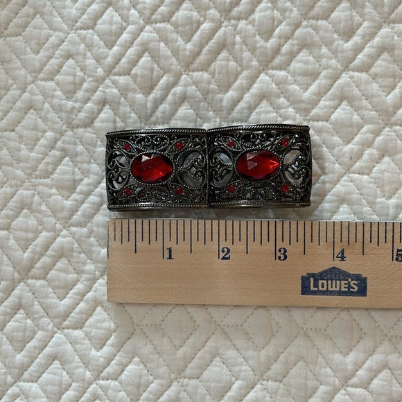 Gunmetal tone stretch bracelet with pretty scrollwork and red stones. - Picture 3 of 4